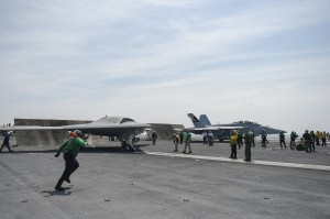 The U.S. Navy's unmanned X-47B conducts flight operations aboard the aircraft carrier USS Theodore Roosevelt (CVN 71). The aircraft completed a series of tests demonstrating its ability to operate safely and seamlessly with manned aircraft. Operating alongside an F/A-18, the X-47B demonstrated two successful launch and recovery sequences. The Theodore Roosevelt is currently underway preparing for future deployments. Photo by Alan Radecki.