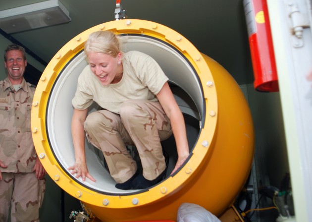 NAVAL SUPPORT ACTIVITY BAHRAIN (May 16, 2013) &ndash; Kpl. Emmylou Bakker, a Dutch Navy diving medical nurse, climbs from a hyperbaric decompression chamber during a mine diving rescue exercise in support of International Mine Countermeasure Exercise 2013. IMCMEX 13 includes navies from more than 40 countries whose focus is to promote regional security through mine countermeasure operations in the U.S. 5th Fleet area of responsibility. (U.S. Navy photo by Mass Communication 1st Class Michael Mui/Released) http://www.flickr.com/photos/navcent/8746249255/in/set-72157633098687339