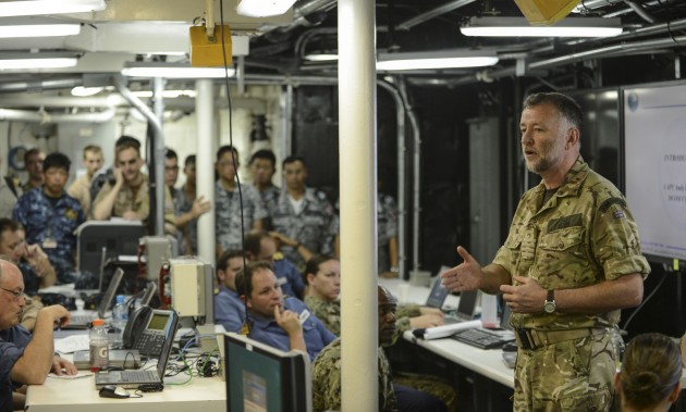 MINA SALMAN PEIR, Bahrain, (May 11, 2013) Capt. Andy Elvin, RN, deputy commander, Commander Task Force 52, UK Mine Countermeasures, speaks to multinational servicemembers aboard USS Ponce (LPD 15) prior to the start of the International Mine Countermeasures Exercise. IMCMEX 13 includes navies from more than 40 countries whose focus is to promote regional security through mine countermeasure operations in the U.S. 5th Fleet area of responsibility. (U.S. Navy photo by Mass Communication Specialist 1st Class Gary Keen/Released) http://www.flickr.com/photos/navcent/8739972653/in/set-72157633098687339