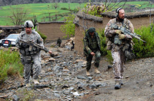 Observer, Mentor, Liaison Team members, Maj. Jim Hickman and Latvian army Maj. Juris Abolins, patrols through the village of Nishagam, in Konar province, Afghanistan alongside members of the Afghan national army, March 18. (U.S. Army photo by Sgt. Matthew Moeller) http://www.nationalguard.mil/news/archives/2009/03/033009-Afghanistan.aspx