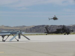 Army Grey Eagle drone (left) and AH-64 Apache (right)