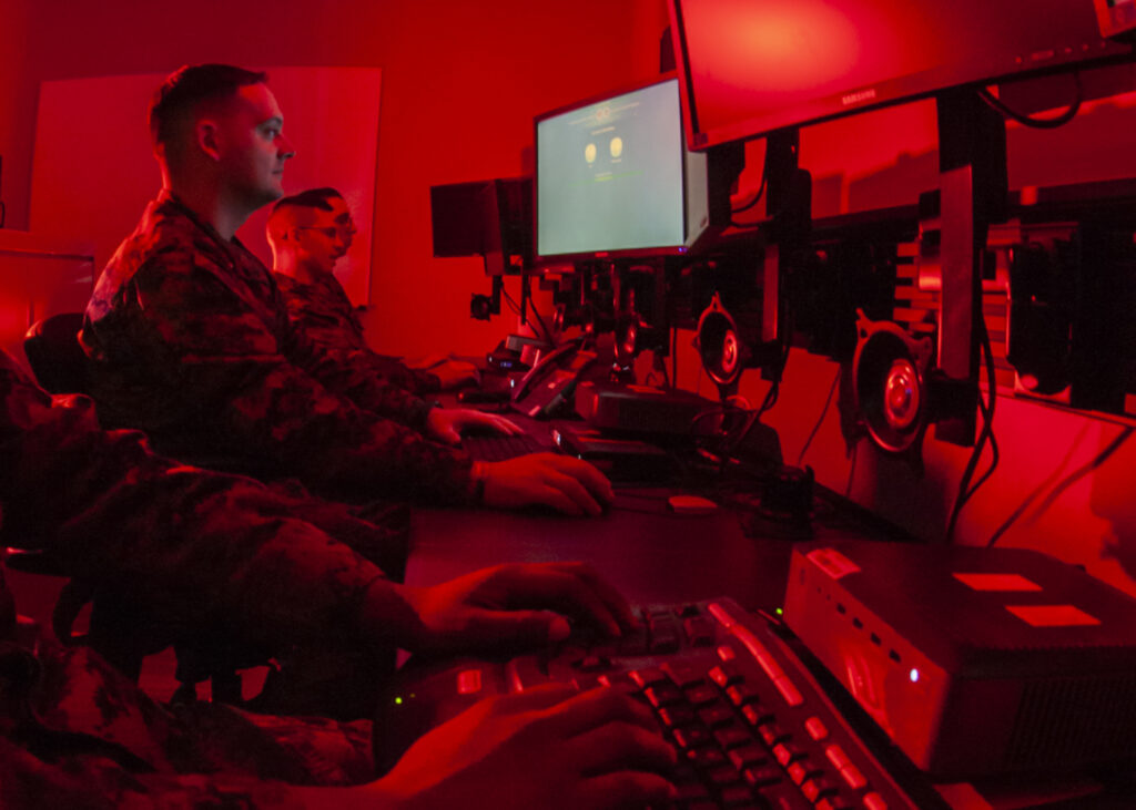 Marines with Marine Corps Forces Cyberspace Command pose for photos in cyber operations room at Lasswell Hall aboard Fort Meade, Maryland, Feb. 5, 2020. MARFORCYBER Marines conduct offensive and defensive cyber operations in support of United States Cyber Command and operate, secure and defend the Marine Corps Enterprise Network.