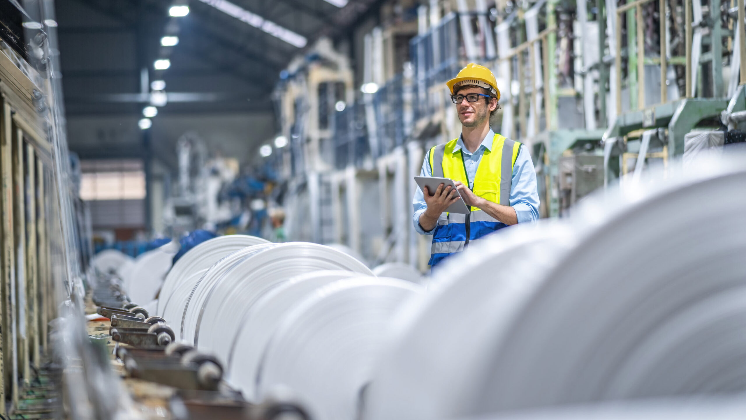 Manufacturers Engineer and tablet working at plastic bag manufacturers.