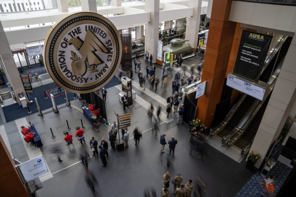 Attendees roam the halls of the Walter E. Washington Convention Center in downtown Washington, DC, Oct. 13, 2025. (Daniel Woolfolk/Breaking Defense)