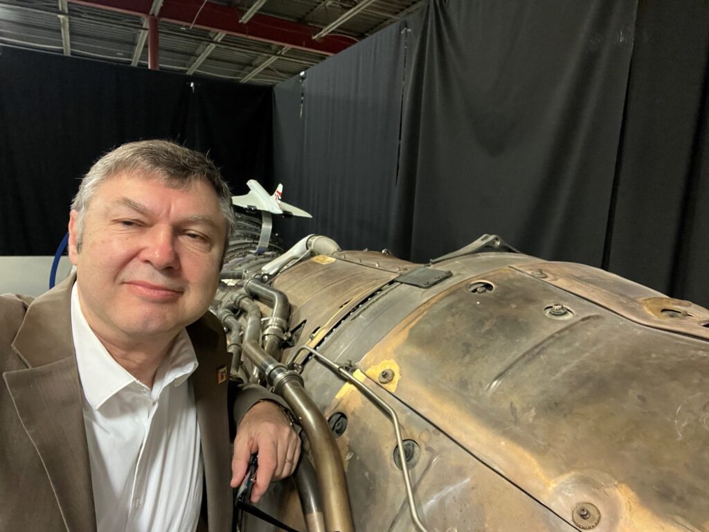 LibertyWorks Research and Technology senior vice president John Kusnierek with a Rolls-Royce Olympus engine used on the Concorde supersonic jet. (Photo courtesy of Rolls-Royce)