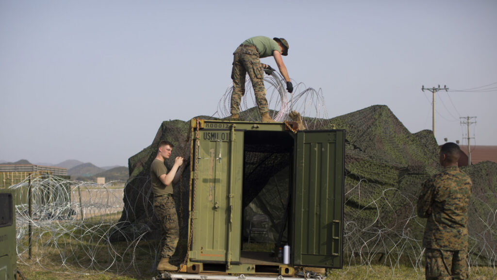 U.S. Marines with Marine Aircraft Group 12 set up c-wire for a temporary sensitive compartmented information facility at Gwangju Air Base, Republic of Korea, during the Fiscal Year 2023 Korea Flying Training, April 19, 2023. KFT 23 is a combined training event focused on tactical execution of combat missions and is part of the ROK-U.S. alliance's routine, annual training program. (U.S. Marine Corps photo by Cpl. Tyler Harmon)