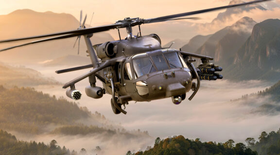 Armed BLACK HAWK helicopter with CLAW wing carrying Modular Effects Launcher and Spike NLOS missiles.