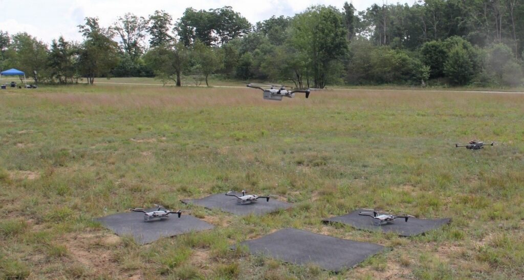 An unmanned aerial system or “Drone” hovers during take-off, to join a “SWARM” of “Drones” at Northern Strike 26-2 in the “Field of Drones,” a UAS and Counter-UAS Controlled Airspace Geospatial Environment or “CAGE” at Camp Grayling, Mich., Aug. 8, 2026. (Photo Credit: Master Sgt. Matthew Chlosta)