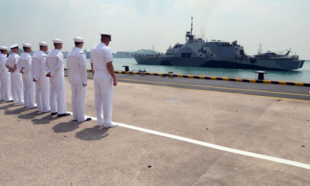 SINGAPORE (April 18, 3013) Sailors attached to Forward Liason Element, USS Freedom (LCS 1), observe Freedom as it arrives in Singapore during an eight-month deployment to Southeast Asia. Fast, agile, and mission focused, LCS platforms are designed to employ modular mission packages that can be configured for three separate purposes: surface warfare, mine countermeasures, or anti-submarine warfare. Freedom will remain homeported in San Diego throughout this deployment to Southeast Asia. (U.S. Navy photo by Mass Communications Specialist 1st Class Jay C. Pugh/Released)
