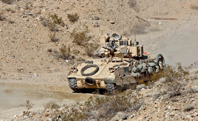 An Army M2 Bradley trains at the National Training Center in California in January. Since then, budget cuts have forced the Army to cancel most such exercises.