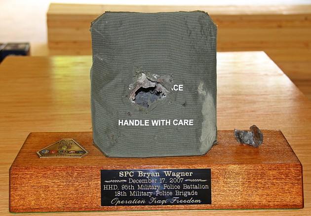 The armor plate that saved Spc. Bryan Wagner's life, and the IED fragment that it stopped.