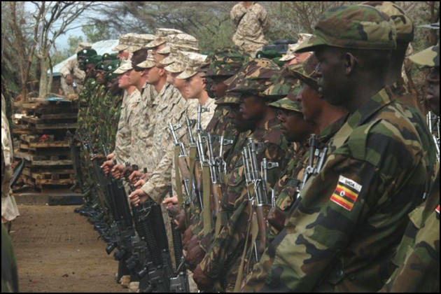 US, Ugandan, Tanzanian, and Kenyan troops stand at attention during a joint exercise.