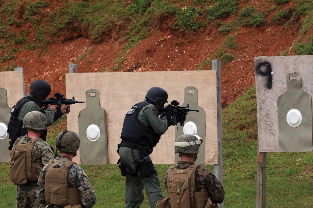 A Guam Police Department SWAT team trains with US Marines. The Pentagon plans to station an additional 5,000 Marines on the island, but its public services and infrastructure aren't yet ready for the influx.