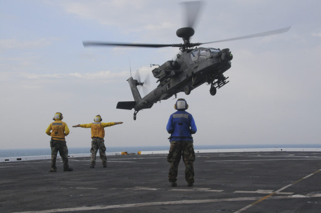 A National Guard AH-64 Apache lands on a Navy ship -- a rare skill in the Army. But the Pentagon's budget plans would move all Guard Apaches to active-duty units.