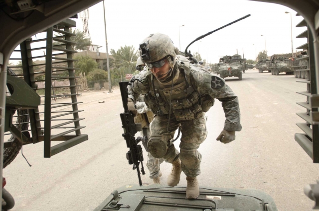 Army soldier with radio entering Stryker - Baghdad -army.mil-2007-05-14-145904