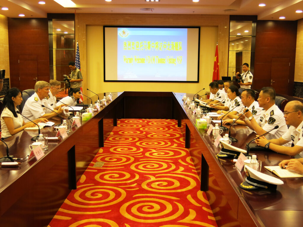 Navy officers from the US (left) and China (right) meet in Qingdao on Monday.