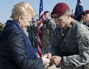 Lithuanian president Dalia Grybauskaite greets a soldier from the 173rd Airborne Brigade during a deployment to deter Russia.