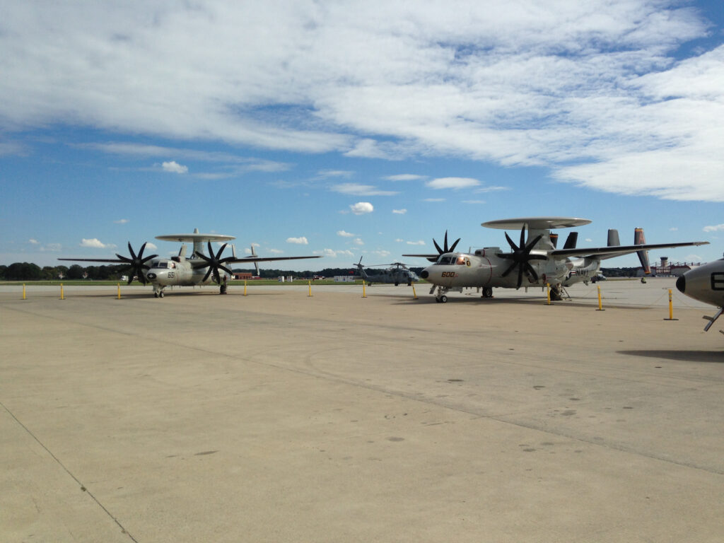 An E-2C Hawkeye (left) and an E-2D Advanced Hawkeye (right). While almost indistinguishable from the outside, the D carries a much more powerful radar and electronics.