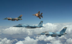 A flight of Aggressor F-15 Eagles and F-16 Fighting Falcons fly in formation over the Nevada Test and Training Ranges on 5 June, 2008. The jets are assigned to the 64th and 65th Aggressor squadrons at Nellis Air Force Base, Nev. The Aggressor mission is to prepare the combat air forces, joint and allied aircrews for tomorrowÕs victories with challenging and realistic threat replication, training, academics and feedback. (U.S. Air Force photo/ Master Sgt. Kevin J. Gruenwald) released