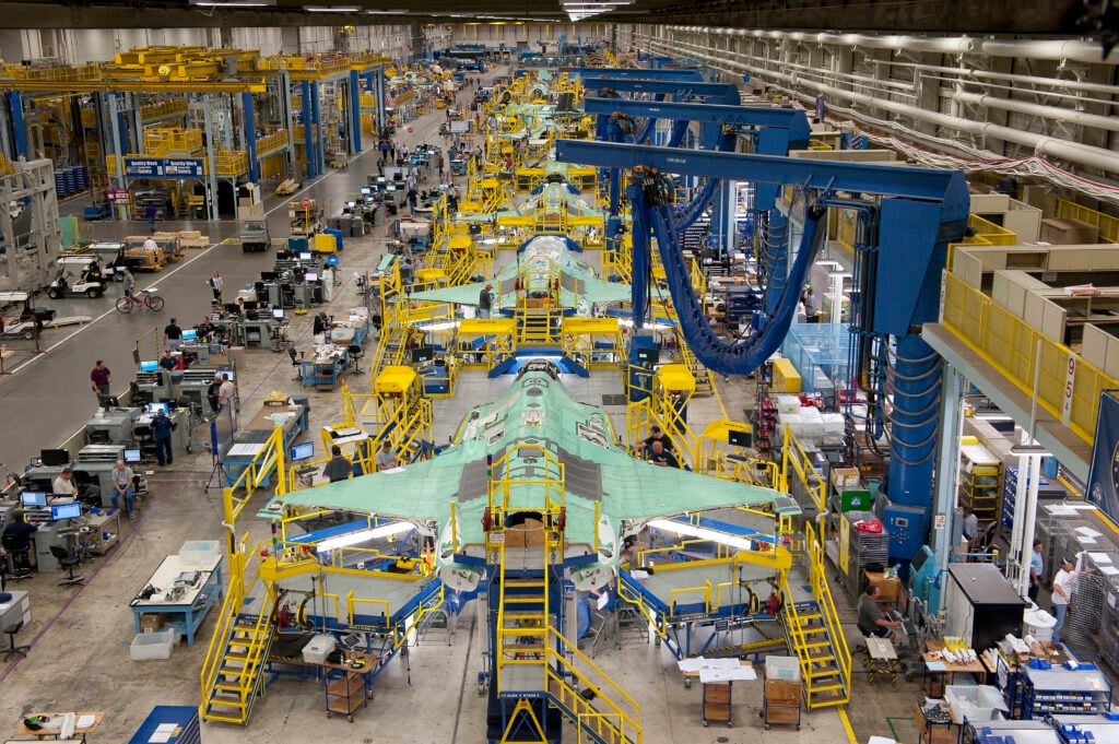 Workers can be seen on the moving line and forward fuselage assembly areas for the F-35 Joint Strike Fighter at Lockheed Martin Corp's factory located in Fort Worth, Texas in this October 13, 2011 handout photo provided by Lockheed Martin. Lockheed Martin Corp on February 25, 2013 said there was no evidence that a lithium-ion battery contributed to a Feb. 14 incident that caused smoke in the cockpit of an F-35 test plane. Lockheed spokesman Michael Rein said initial reviews indicated a potential failure in the plane's cooling system, which had been removed from the aircraft for further study. Picture taken October 13, 2011. REUTERS/Lockheed Martin/Randy A. Crites/Handout (UNITED STATES - Tags: MILITARY) ATTENTION EDITORS - THIS IMAGE WAS PROVIDED BY A THIRD PARTY. FOR EDITORIAL USE ONLY. NOT FOR SALE FOR MARKETING OR ADVERTISING CAMPAIGNS. THIS PICTURE IS DISTRIBUTED EXACTLY AS RECEIVED BY REUTERS, AS A SERVICE TO CLIENTS - RTR3EAKJ