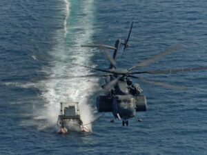 An MH-53E Sea Dragon tows a mine-clearing "sled" during exercises