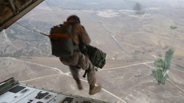 A Radio Battalion marine parachutes in an exercise.