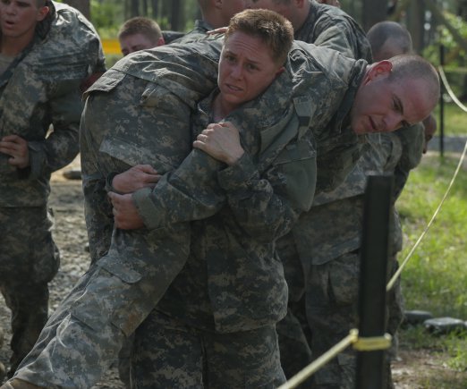 Woman Ranger in training Maj. Lisa Jaster, an Army Reserve soldier, performs a fireman's carry on a simulated casualty during the Ranger Course on Ft. Benning, GA. The 37-year-old engineer and mother of two children, aged 7 and 3, is the first female Army Reserve officer to graduate the grueling combat leadership course, joining the ranks of fellow West Point graduates and Active Duty officers Capt. Kristen Griest, 26, and 1st Lt. Shaye Haver, 25. 