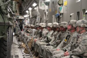 Strykers and Army soldiers on C-17