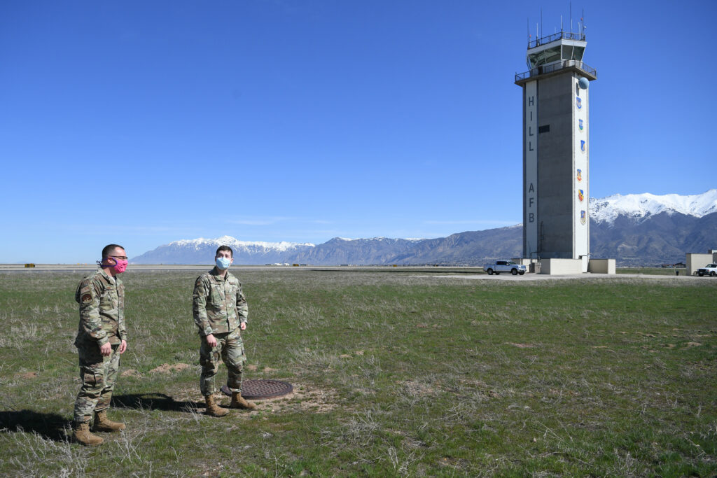 Tech. Sgt. Miles Sumner, left, and Senior Airman Corbyn Peterson, 75th Operations Support Squadron, go outside to observe the weather. During the COVID-19 pandemic, the weather shop has been scheduling one person on while the rest of the team works remotely, except when there is training. (U.S. Air Force photo by Cynthia Griggs)