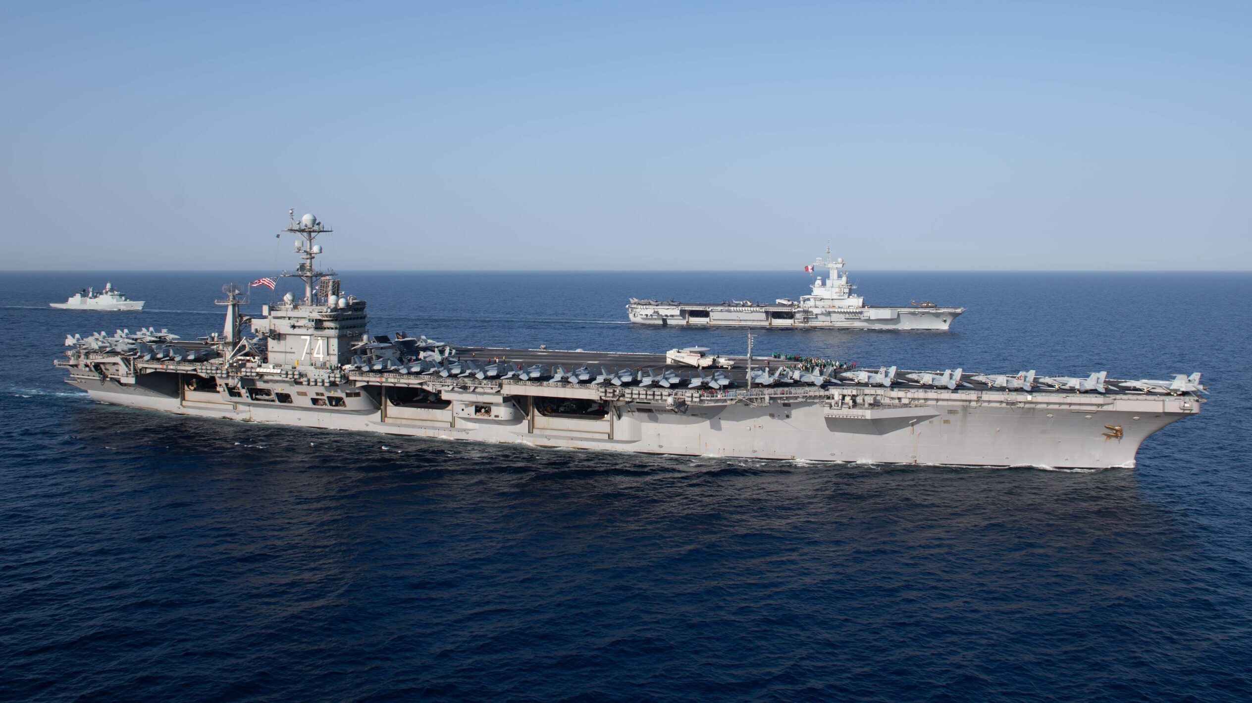 The Charles de Gaulle Carrier Strike Group and the John C. Stennis Carrier Strike Group conduct operations at sea