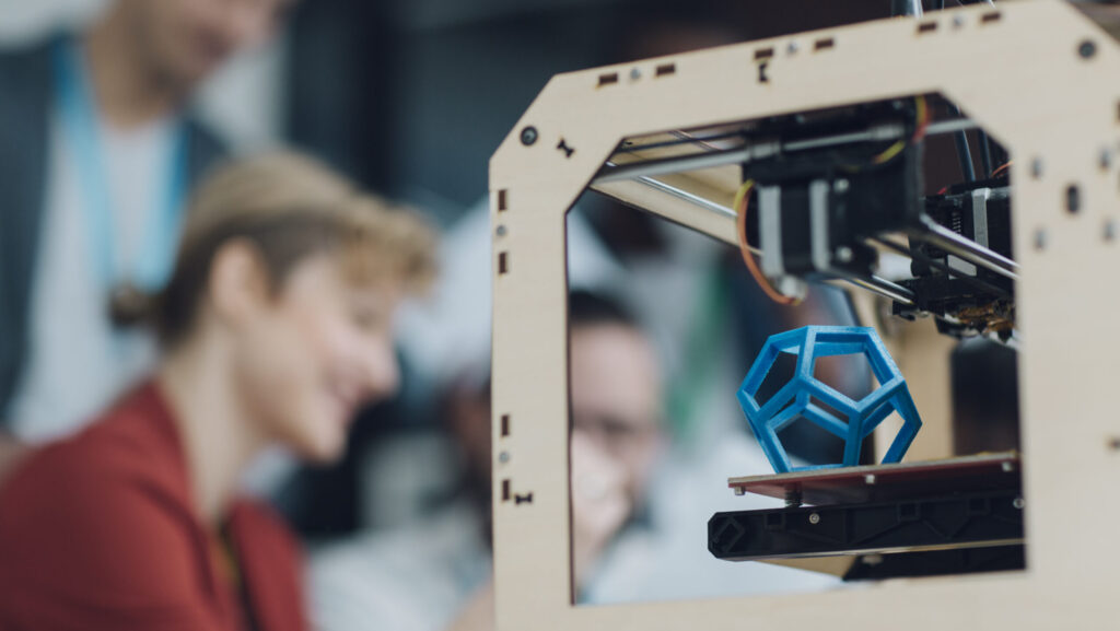 Creative Start-Up Business Team Working by 3D Printer.