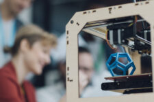 Creative Start-Up Business Team Working by 3D Printer.