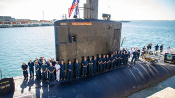 AUKUS Announcement The crew of USS Asheville assemble on the casing of the submarine during their visit to HMAS Stirling in Rockingham, Western Australia. *** Local Caption *** On 14 March 2023, the Government announced the first initiative under an enhanced trilateral security partnership with the United Kingdom and the United States (AUKUS) that will identify the optimal pathway for the acquisition of at least eight nuclear-powered submarines for the Royal Australian Navy.