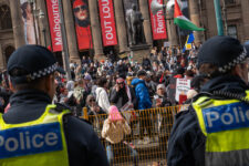 A protester with her underwear over her head as she gestures