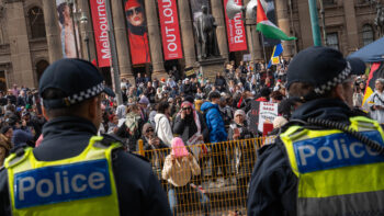 A protester with her underwear over her head as she gestures