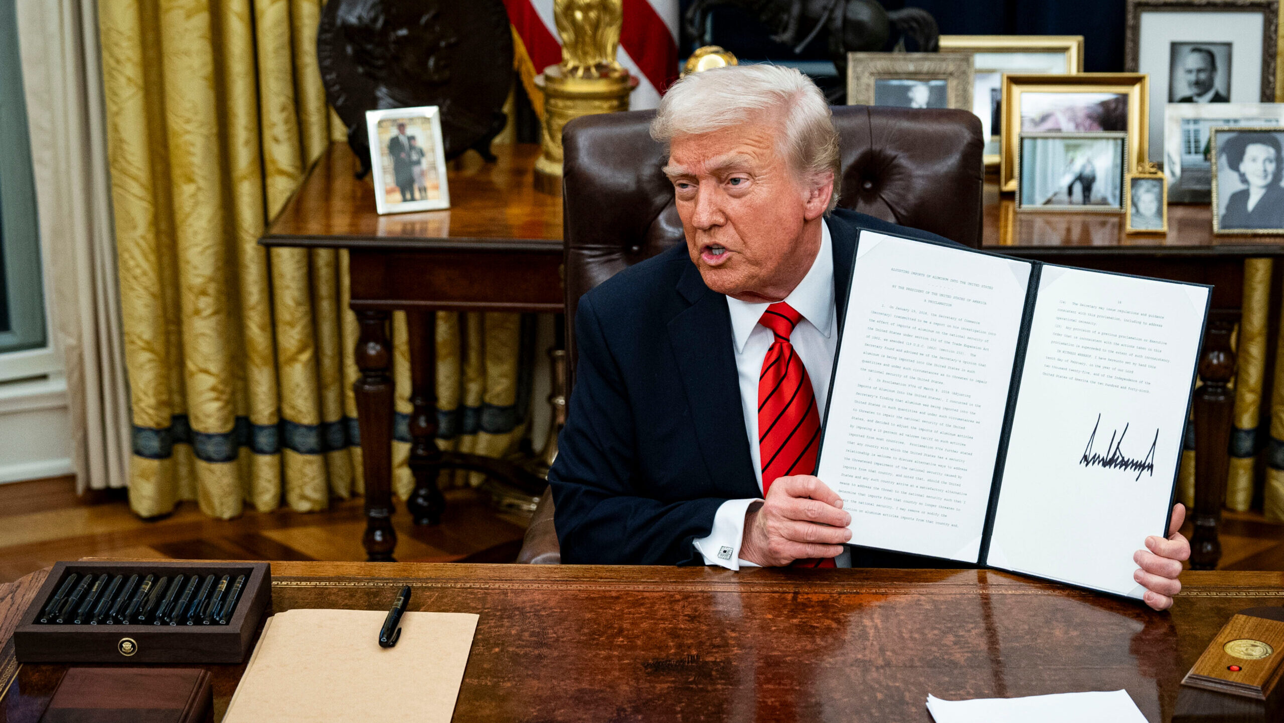 arafed president donald trump sitting at a desk with papers